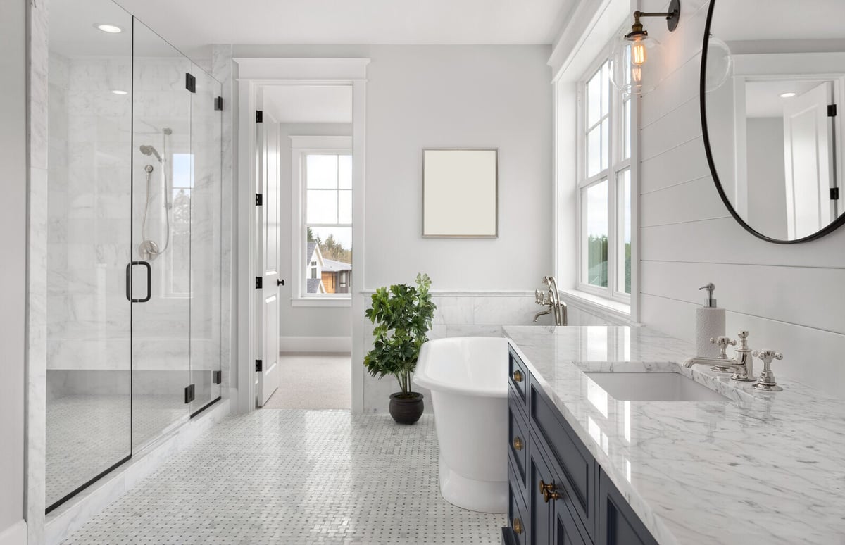 Luxurious bathroom remodel with marble finishes and a standalone tub by Crosby Home Services in Prescott, AZ