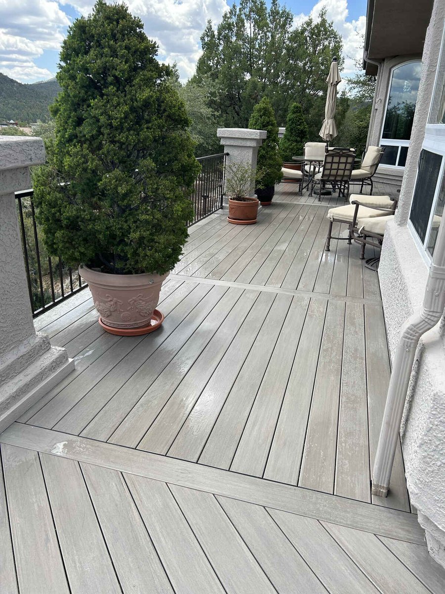 Contemporary outdoor deck with railing and potted trees by Crosby Home Services in Prescott, AZ